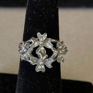 Antique Unique Open Flowers Adjustable Unmarked Silver Ring sits at a 5.5